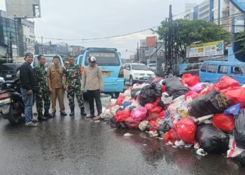 Aroma Menyengat Tak Hentikan Babinsa Ciputat dan DLH Bersihkan Sampah di Jalan Ir Juanda